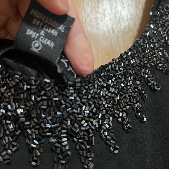 Elegant Black Sleeveless Dress with Embellished Neckline - Picture 3 of 5